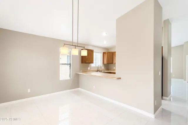 a large white kitchen with kitchen island a sink a stove and a refrigerator
