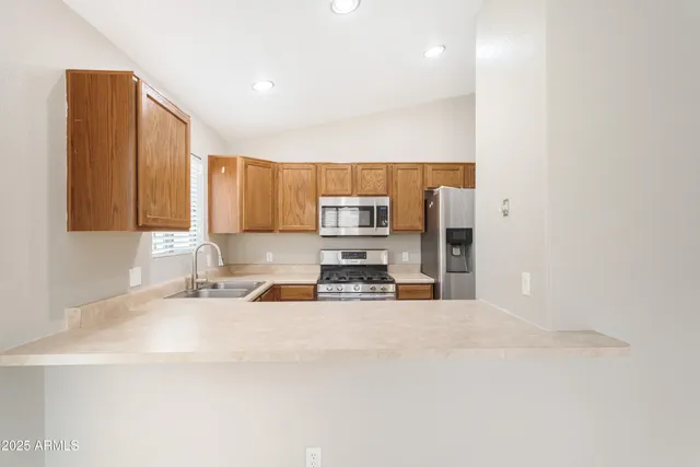 a kitchen with stainless steel appliances a sink and a microwave