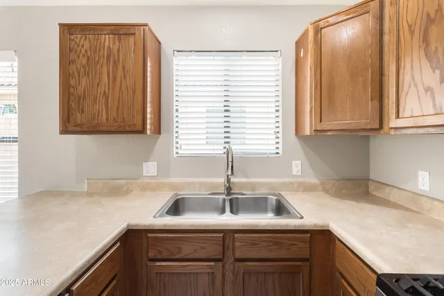 a kitchen with a sink cabinets and window