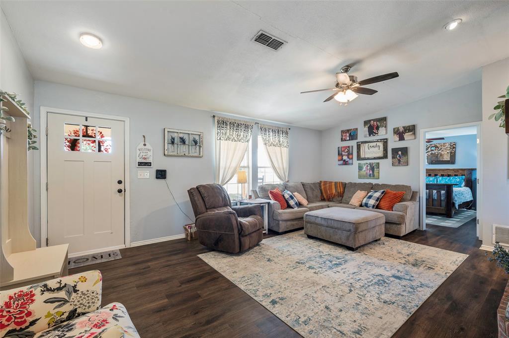 8229 East Lone Oak Road Valley View, TX 76272 - Photo 3 of 22 a living room with furniture and wooden floor