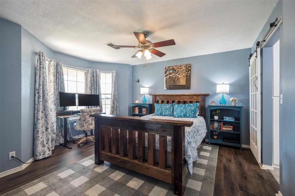 8229 East Lone Oak Road Valley View, TX 76272 - Photo 8 of 22 a bedroom with furniture and a window