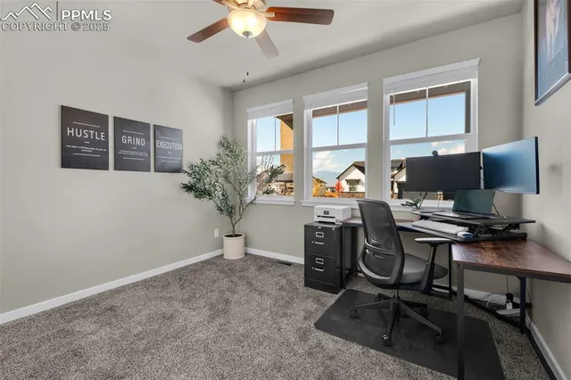 a view of a workspace with furniture and a window