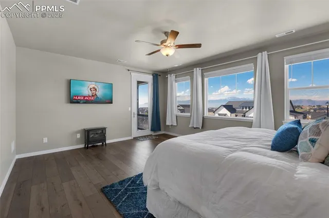 a bedroom with a bed and a large window