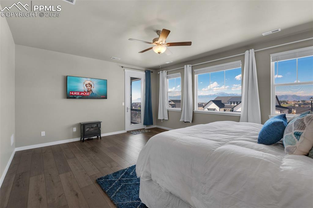 9755 Owl Perch Loop Colorado Springs, CO 80908 - Photo 20 of 50 a bedroom with a bed and a large window