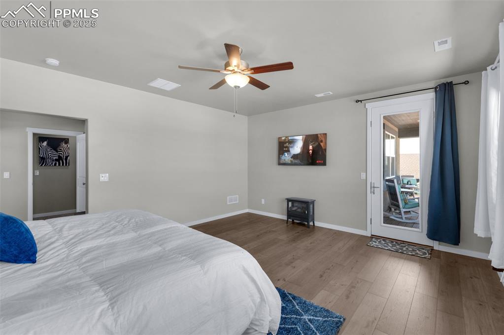 9755 Owl Perch Loop Colorado Springs, CO 80908 - Photo 22 of 50 a bedroom with a bed and a flat screen tv