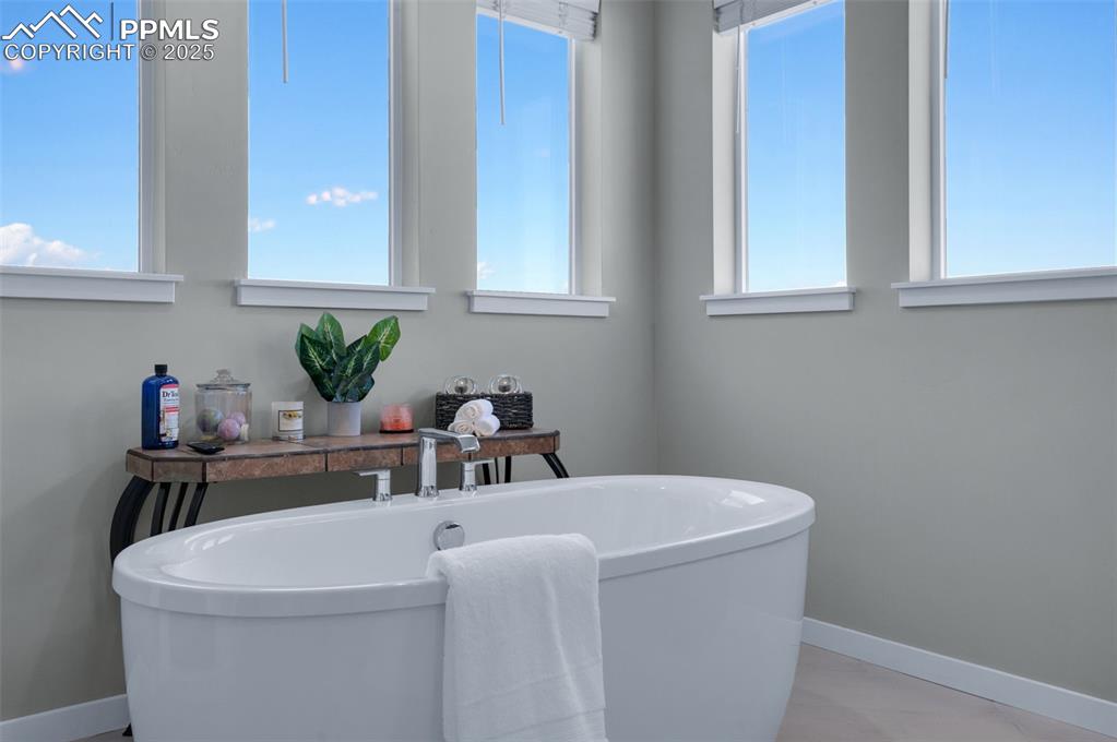 9755 Owl Perch Loop Colorado Springs, CO 80908 - Photo 24 of 50 a bathroom with a sink a toilet and a mirror