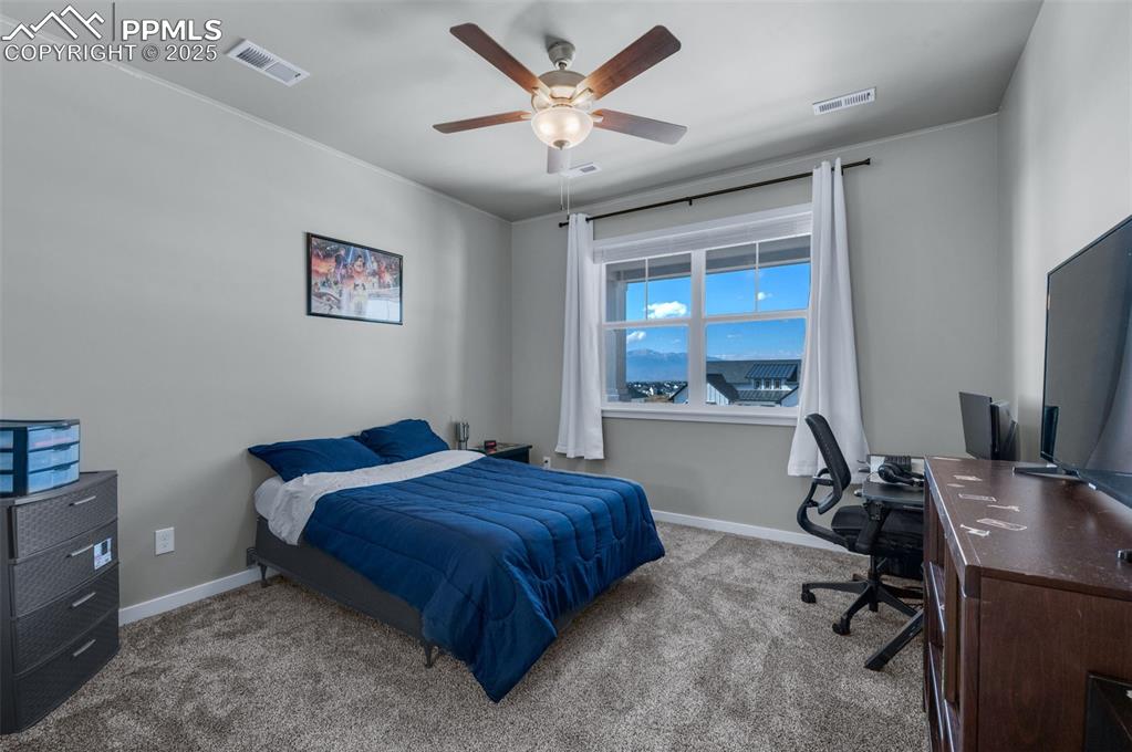 9755 Owl Perch Loop Colorado Springs, CO 80908 - Photo 29 of 50 a bedroom with a bed and a desk