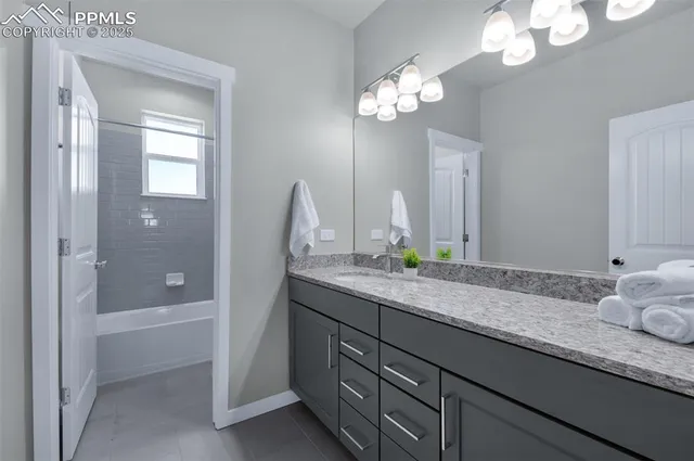 a bathroom with a granite countertop sink a toilet and a mirror