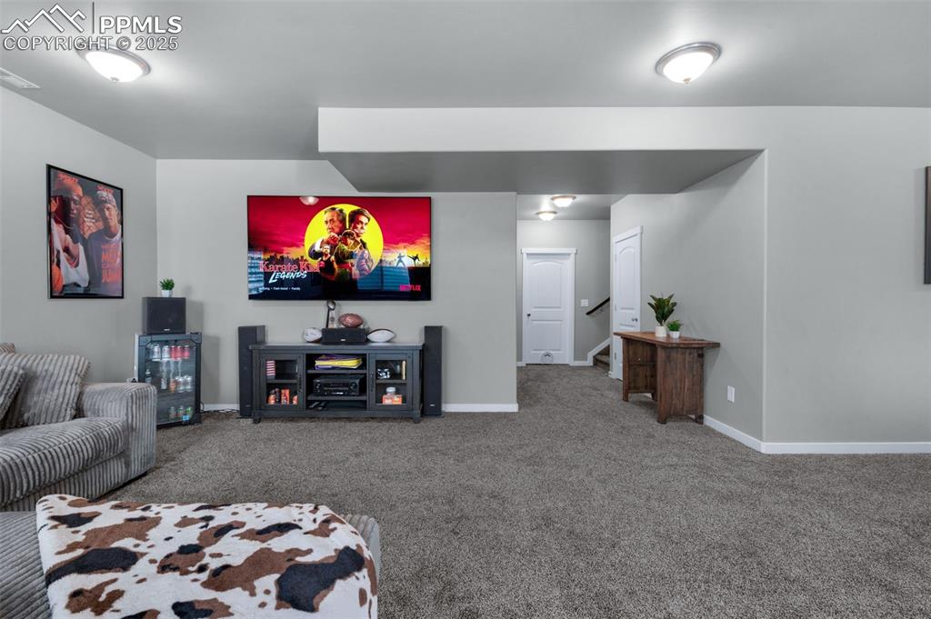 9755 Owl Perch Loop Colorado Springs, CO 80908 - Photo 37 of 50 a living room with furniture and a flat screen tv