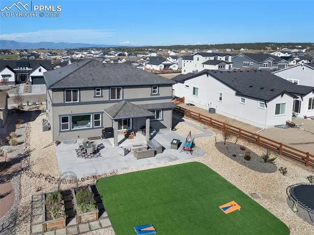 an aerial view of a house with swimming pool and patio
