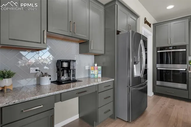 a kitchen with stainless steel appliances granite countertop a refrigerator and a sink