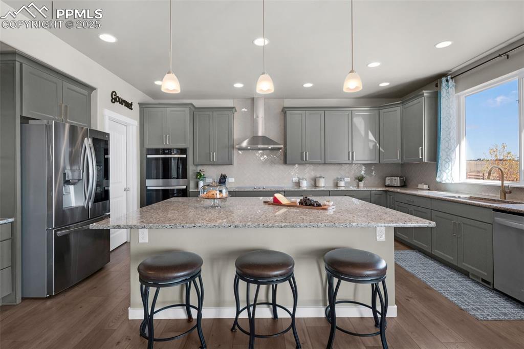 9755 Owl Perch Loop Colorado Springs, CO 80908 - Photo 8 of 50 a kitchen with stainless steel appliances granite countertop a table chairs sink refrigerator and microwave