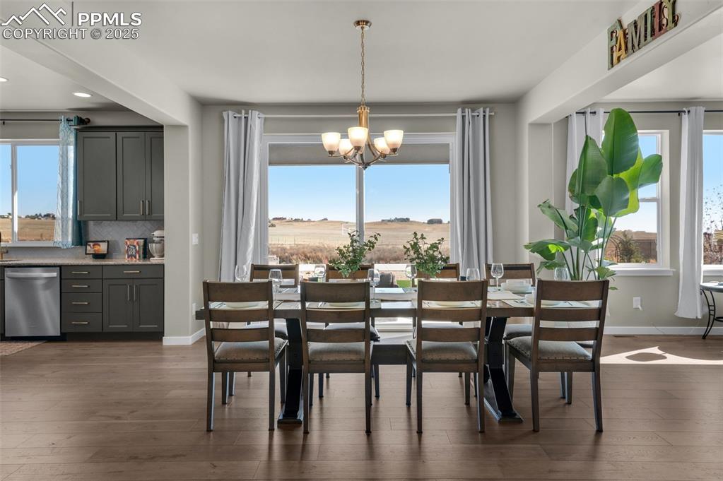 9755 Owl Perch Loop Colorado Springs, CO 80908 - Photo 9 of 50 a view of a dining room with furniture window and wooden floor
