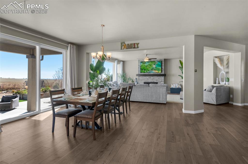 9755 Owl Perch Loop Colorado Springs, CO 80908 - Photo 10 of 50 a view of a dining room with furniture and wooden floor