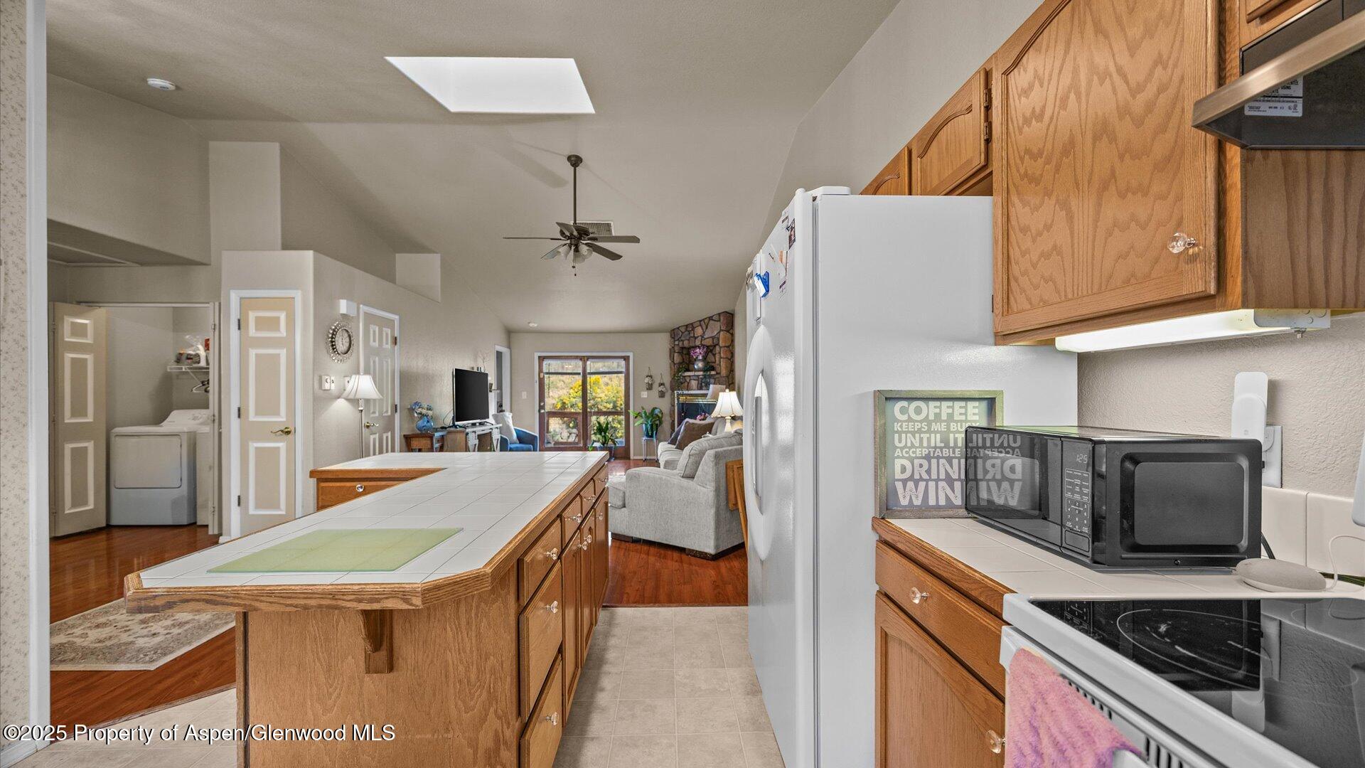 9 West Ridge Court, Unit 1113 Parachute, CO 81635 - Photo 11 of 27 a kitchen with stainless steel appliances granite countertop a sink and a refrigerator