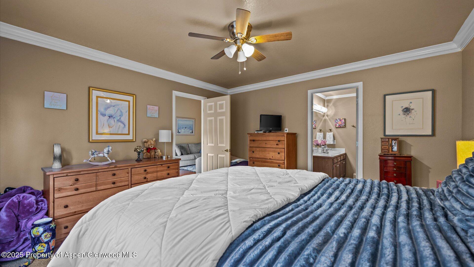 9 West Ridge Court, Unit 1113 Parachute, CO 81635 - Photo 13 of 27 a bedroom with a bed and a chandelier