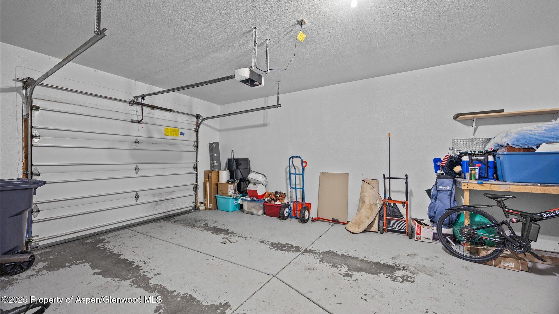 9 West Ridge Court, Unit 1113 Parachute, CO 81635 - Photo 18 of 27 a view of a garage with rack and bicycle
