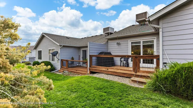 a aerial view of a house with a yard and potted plants
