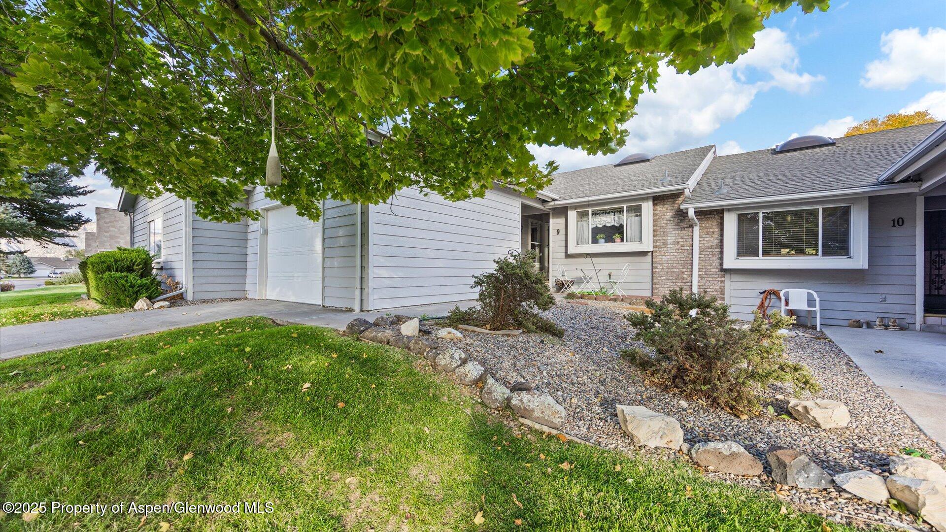 9 West Ridge Court, Unit 1113 Parachute, CO 81635 - Photo 2 of 27 a front view of a house with garden
