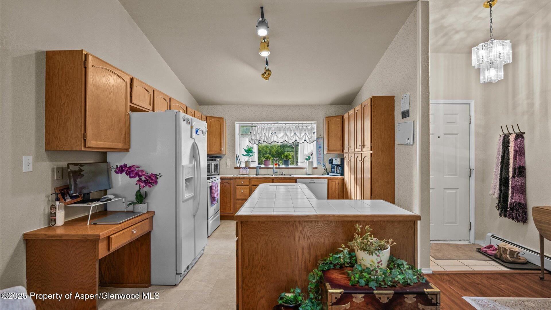 9 West Ridge Court, Unit 1113 Parachute, CO 81635 - Photo 7 of 27 a view of kitchen with kitchen island stainless steel appliances granite countertop cabinets and a counter top space