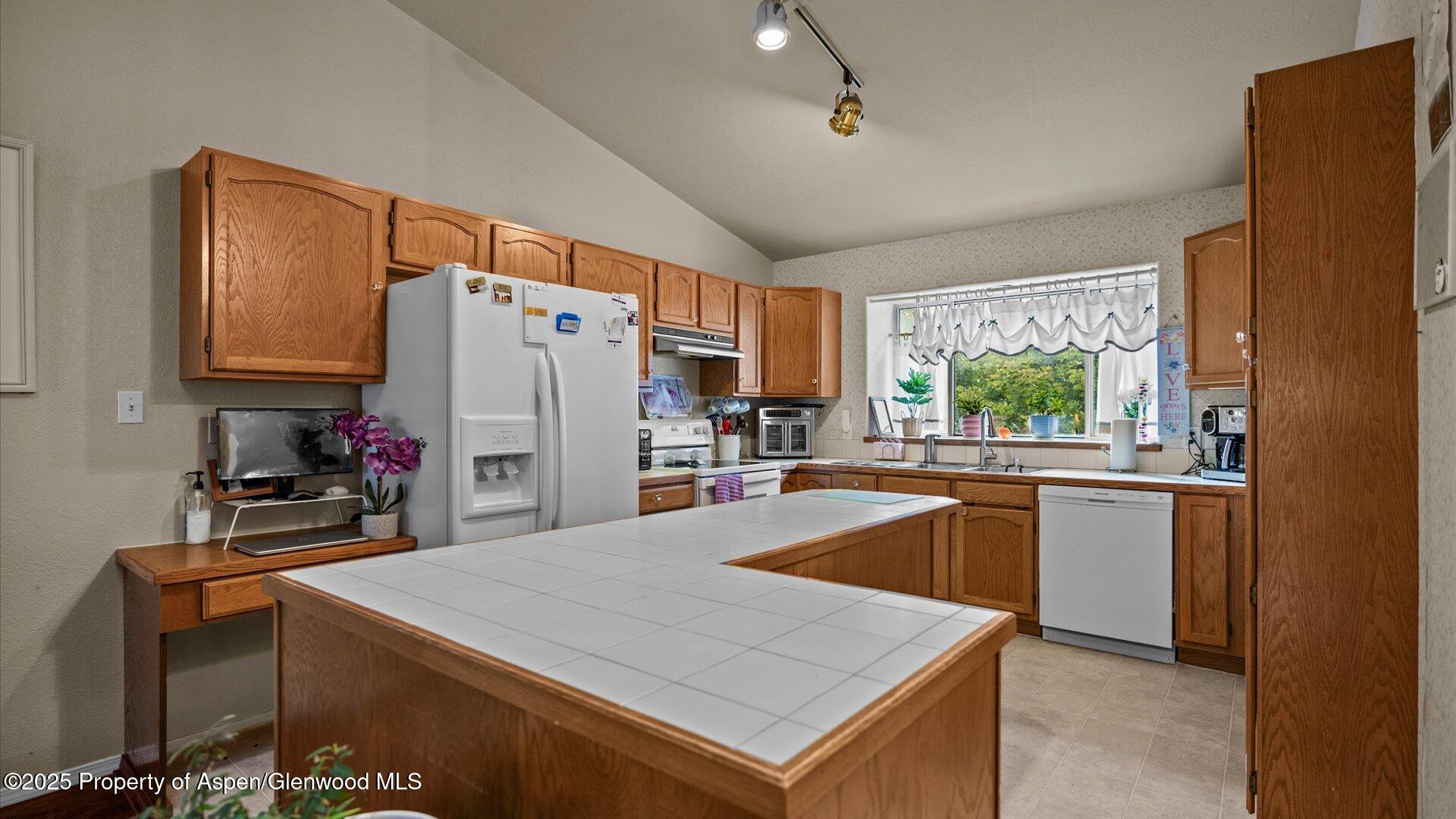9 West Ridge Court, Unit 1113 Parachute, CO 81635 - Photo 9 of 27 a kitchen with a refrigerator a stove a sink and a microwave
