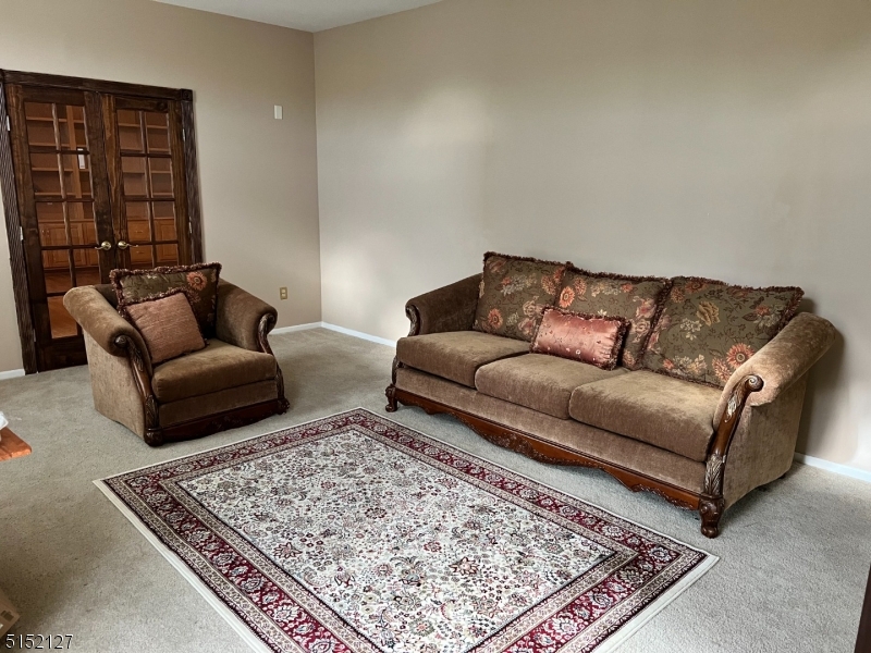 7 Rymon Road Washington, NJ 07882 - Photo 4 of 15 a living room with furniture and a rug
