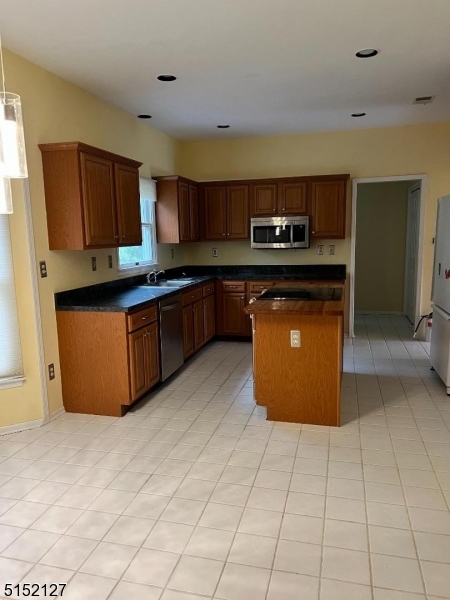 7 Rymon Road Washington, NJ 07882 - Photo 8 of 15 a kitchen with stainless steel appliances granite countertop a stove a sink and a refrigerator