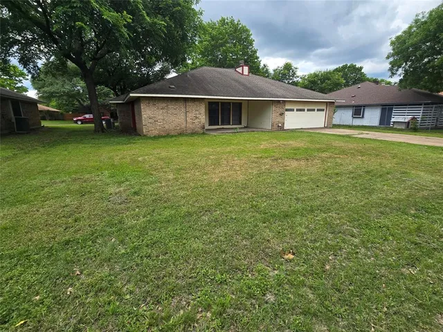 a view of a house with a yard and sitting area