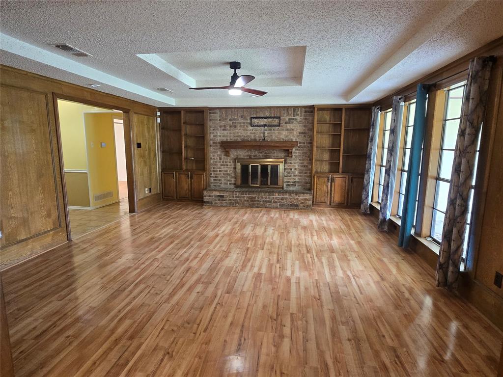 925 Shell Lane Lancaster, TX 75146 - Photo 3 of 10 wooden floor in an empty room with a fireplace