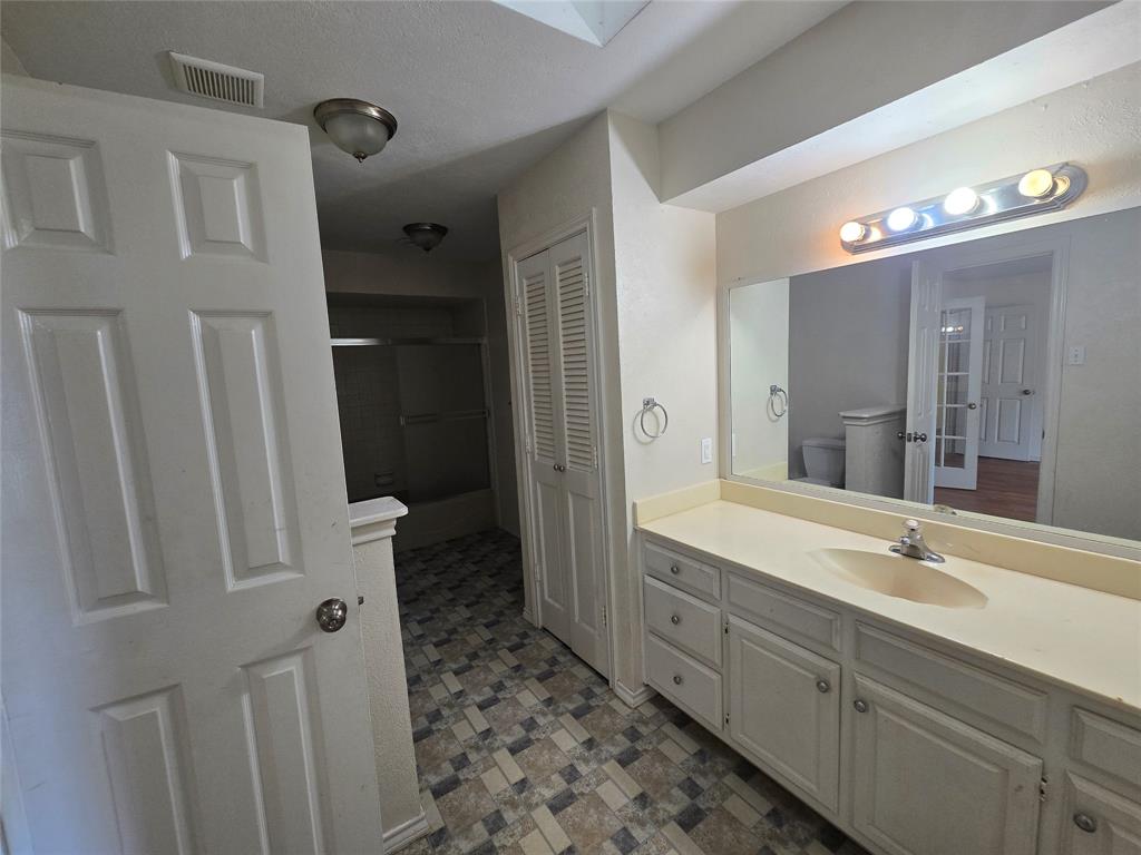 925 Shell Lane Lancaster, TX 75146 - Photo 7 of 10 a spacious bathroom with a double vanity sink a toilet and a shower