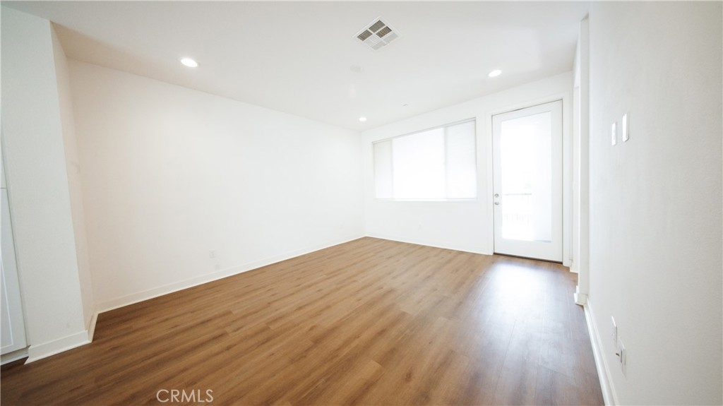 320 Bridgewater Way, Unit 7 Gardena, CA 90247 - Photo 18 of 41 a view of empty room with wooden floor and fan