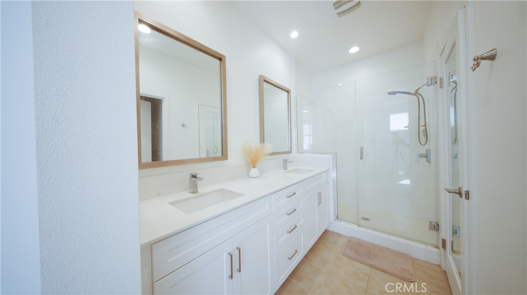 320 Bridgewater Way, Unit 7 Gardena, CA 90247 - Photo 30 of 41 a bathroom with a double vanity sink a shower and a mirror