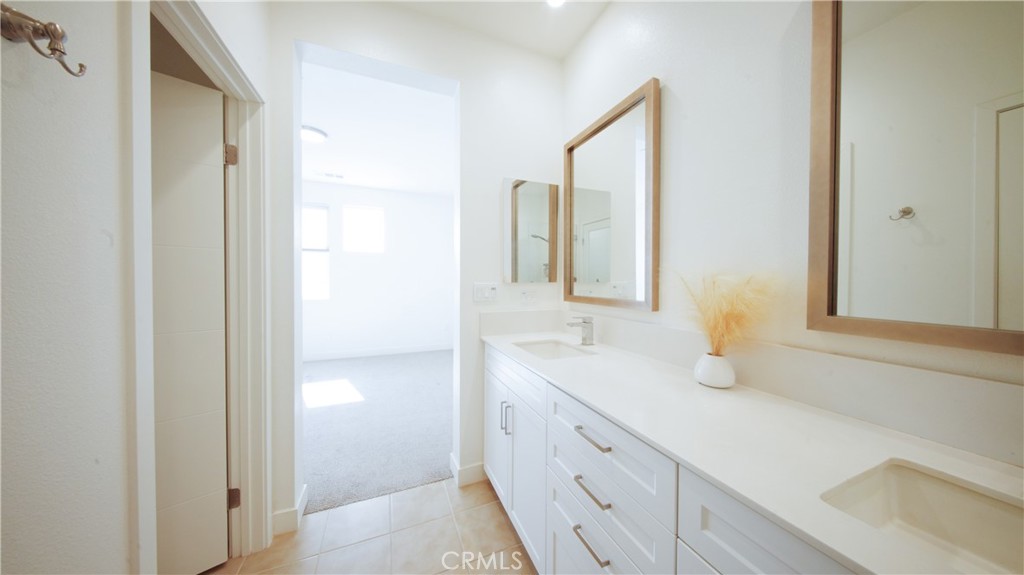 320 Bridgewater Way, Unit 7 Gardena, CA 90247 - Photo 31 of 41 a bathroom with a double vanity sink and mirror