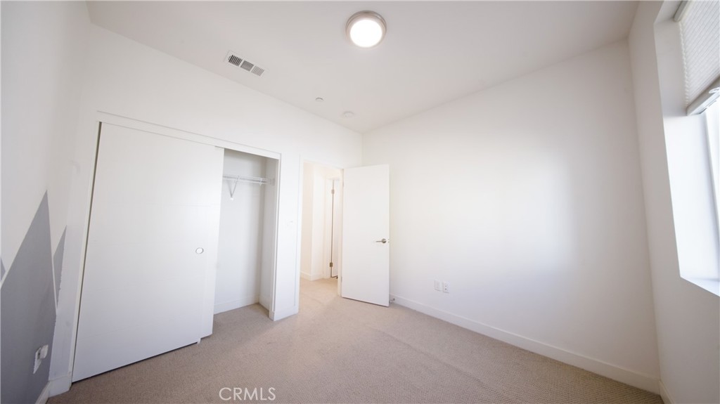 320 Bridgewater Way, Unit 7 Gardena, CA 90247 - Photo 35 of 41 an empty room with windows and closet