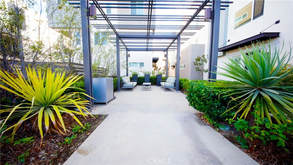 320 Bridgewater Way, Unit 7 Gardena, CA 90247 - Photo 39 of 41 a view of a garden with plants and a bench