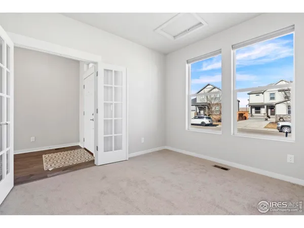 a view of an empty room with window and cabinet