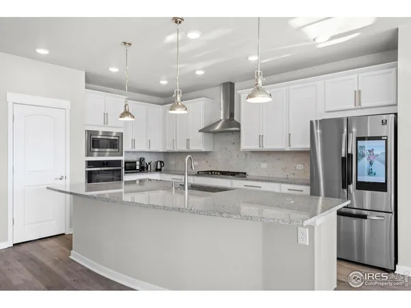 a kitchen with kitchen island a counter space stainless steel appliances and cabinets