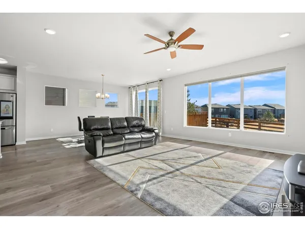 a living room with furniture and a floor to ceiling window