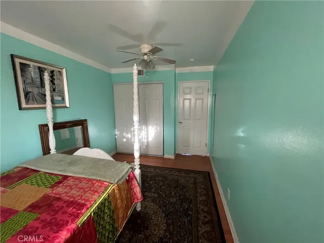 a bedroom with a large bed and a chandelier