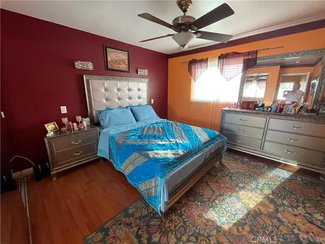 a bedroom with a bed window and dresser