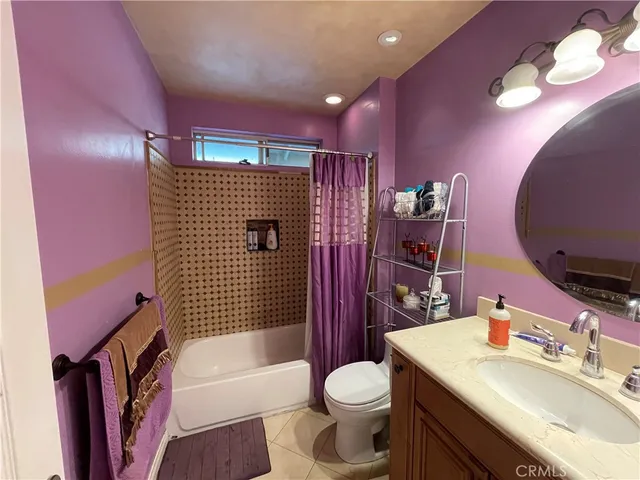 a bathroom with a sink toilet vanity tub and shower