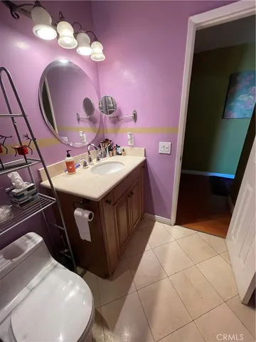 a bathroom with a sink mirror and vanity