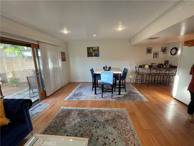 a living room with furniture rug and wooden floor