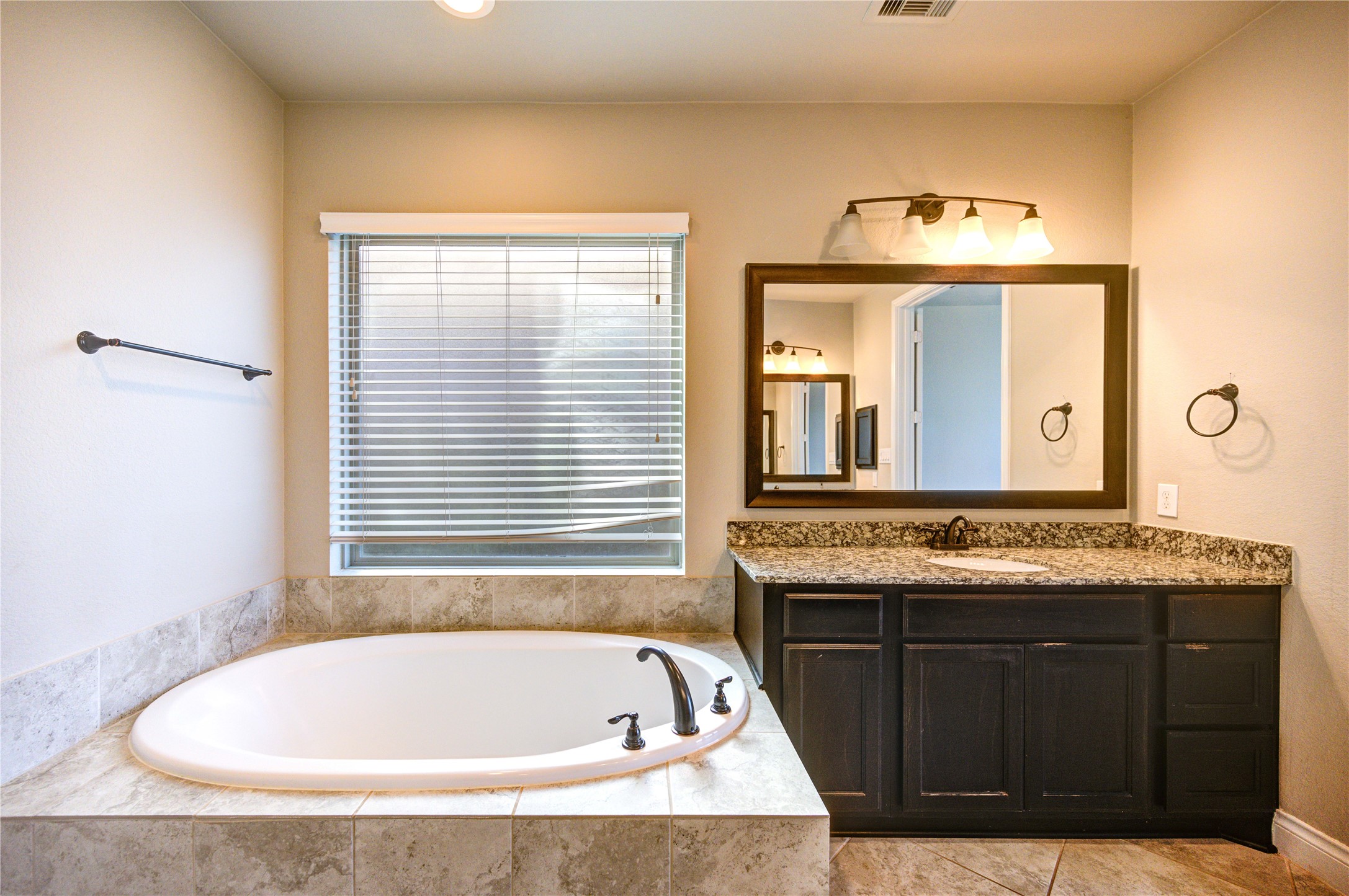 4207 Abigail Way Sugar Land, TX 77479 - Photo 25 of 48 a bath tub sitting in a bathroom next to a window