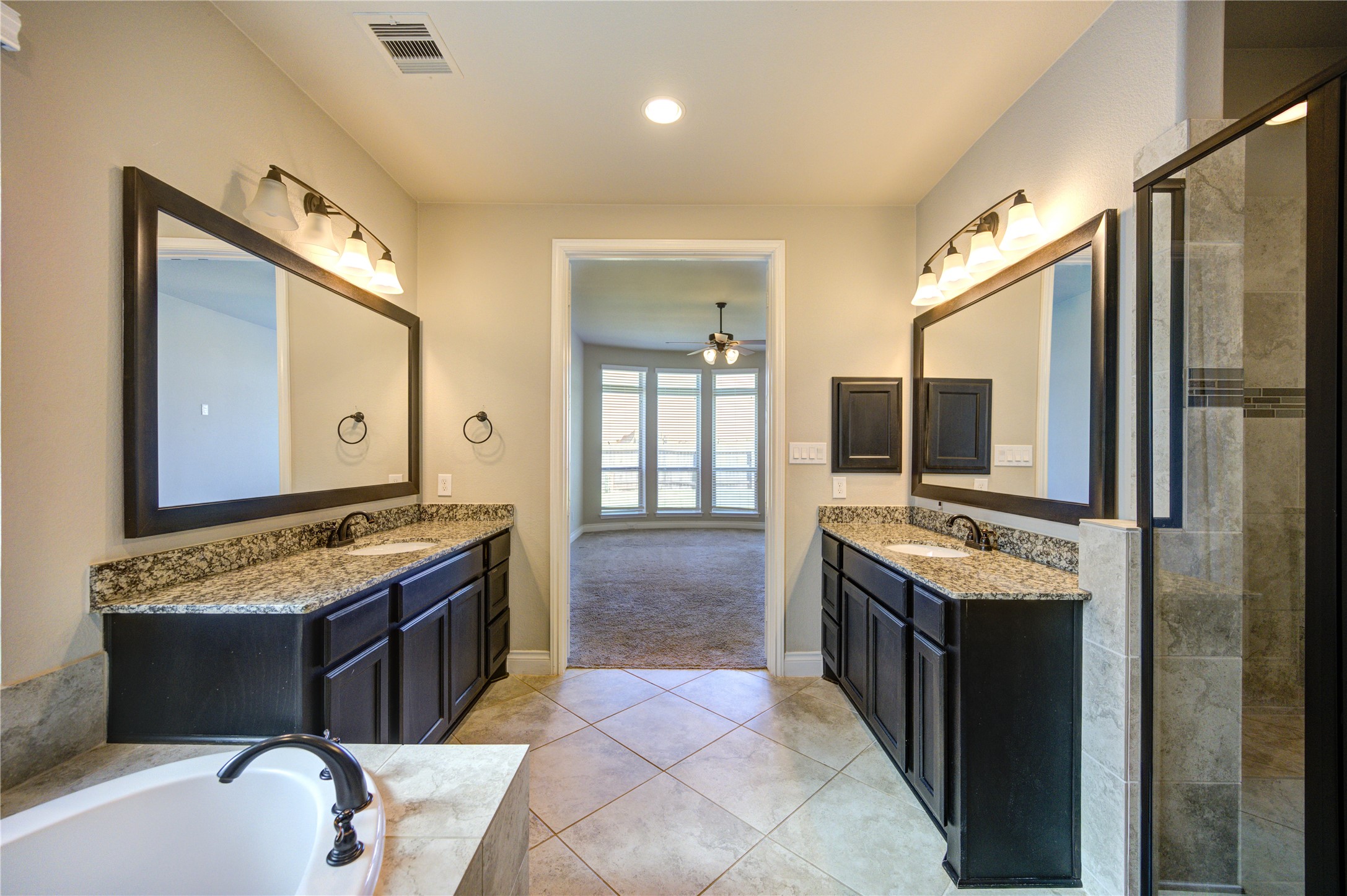 4207 Abigail Way Sugar Land, TX 77479 - Photo 28 of 48 a spacious bathroom with a granite countertop tub sink and mirror