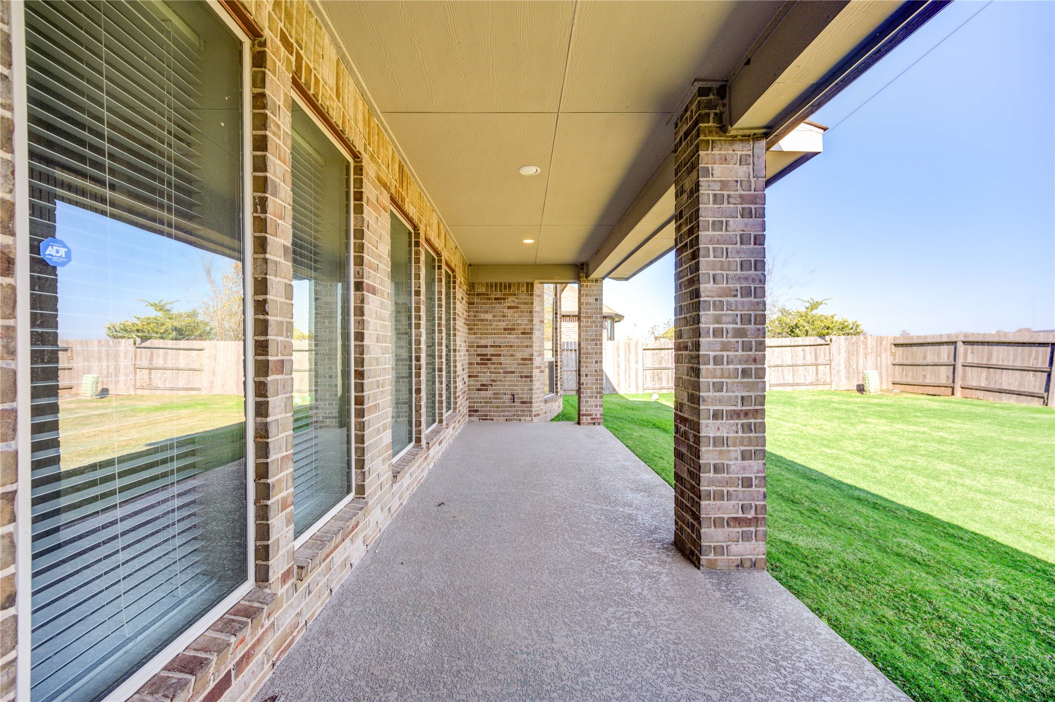 4207 Abigail Way Sugar Land, TX 77479 - Photo 47 of 48 a view of a porch with a big yard potted plants and floor to ceiling window