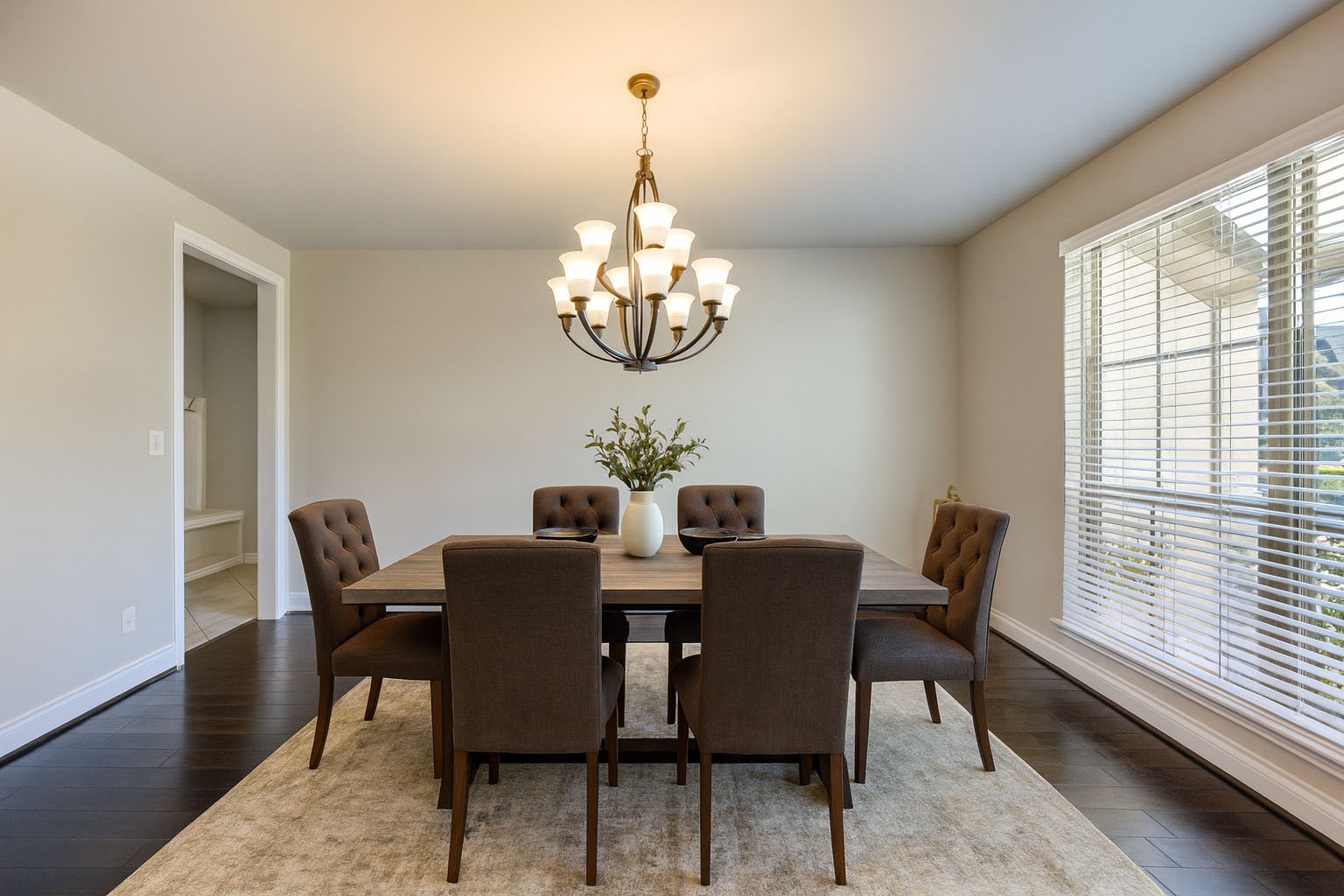 4207 Abigail Way Sugar Land, TX 77479 - Photo 5 of 48 a dining room with wooden floor a chandelier a wooden table and chairs
