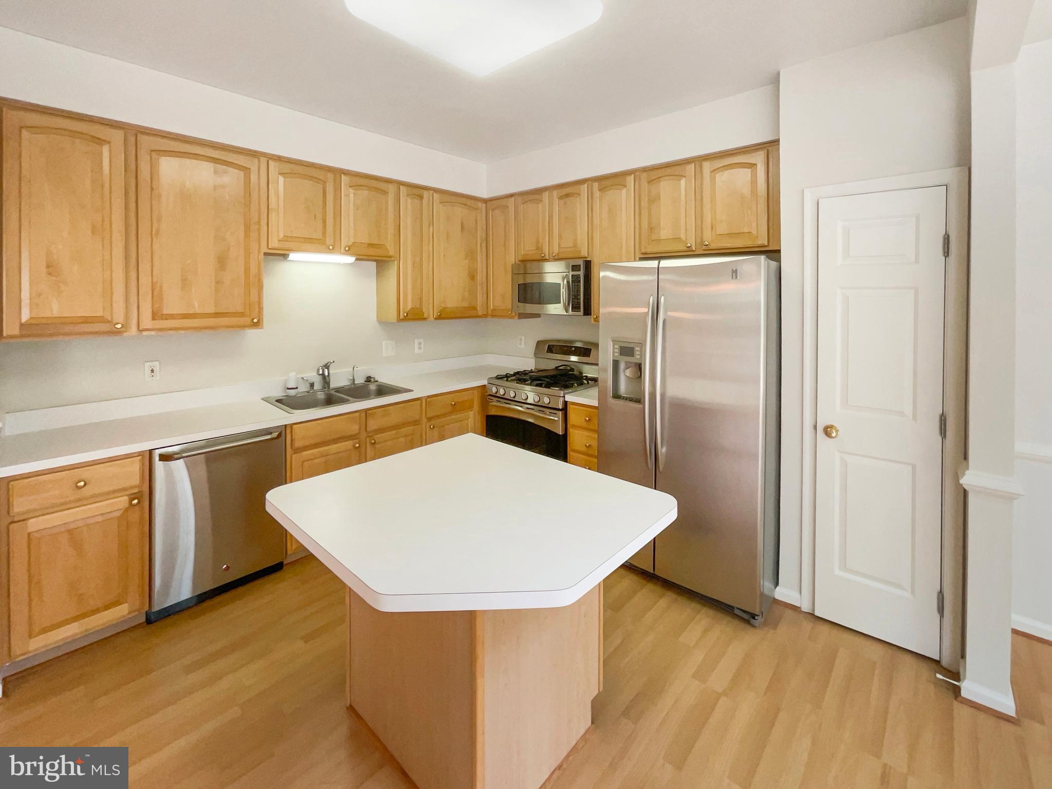 14272 Glade Spring Drive Centreville, VA 20121 - Photo 11 of 46 a kitchen with stainless steel appliances a refrigerator sink and cabinets