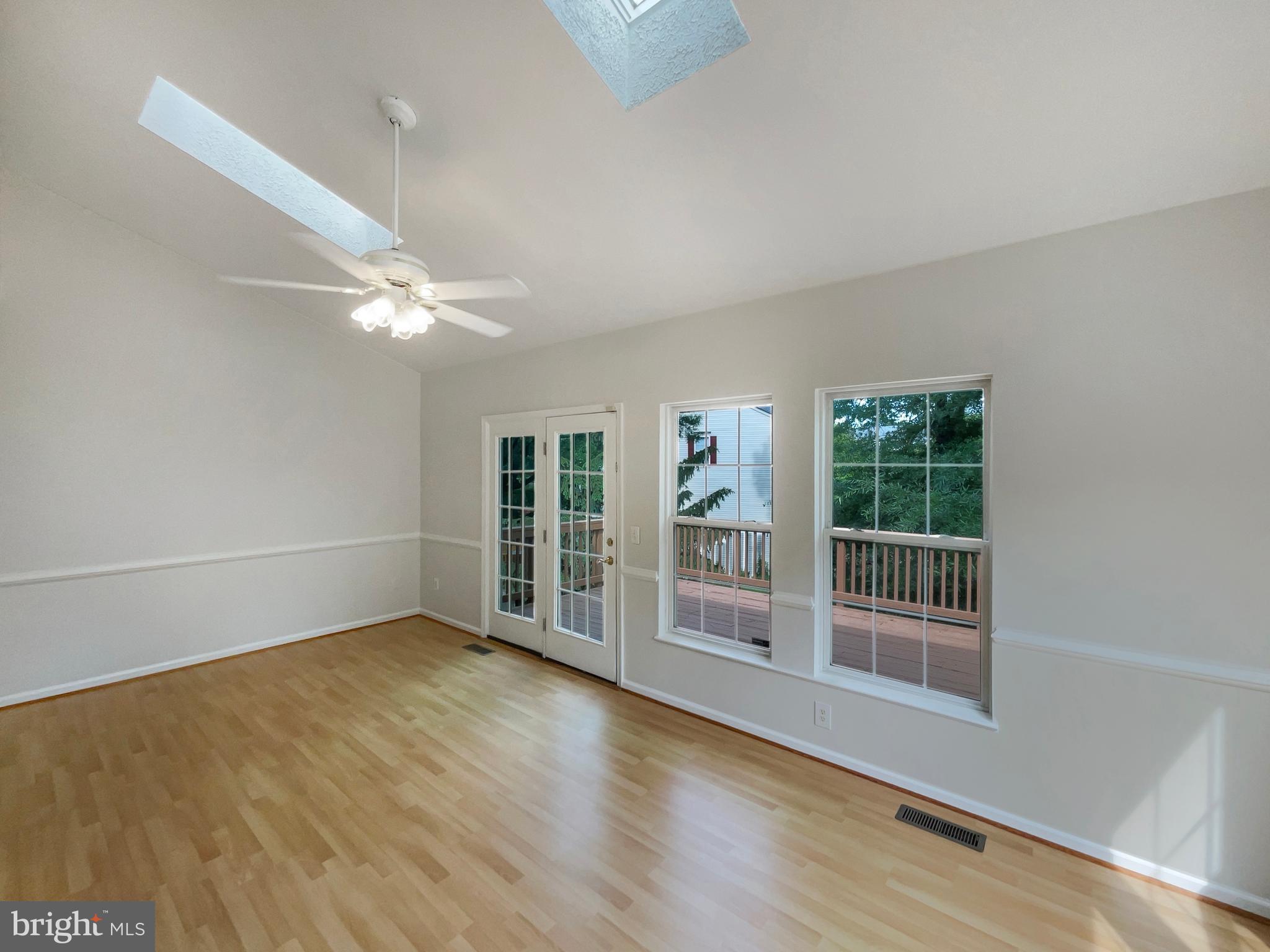 14272 Glade Spring Drive Centreville, VA 20121 - Photo 14 of 46 an empty room with wooden floor fan and windows