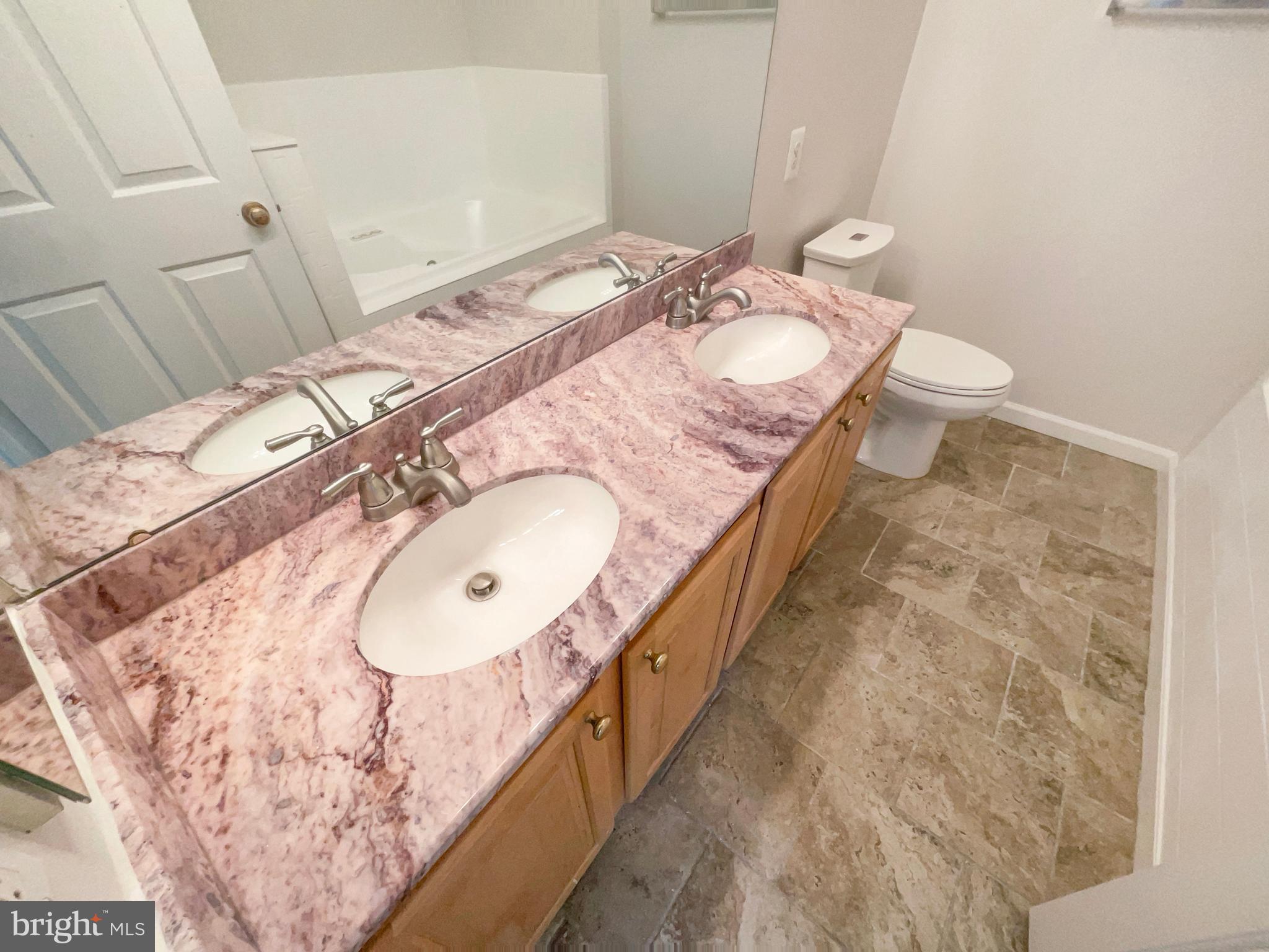 14272 Glade Spring Drive Centreville, VA 20121 - Photo 23 of 46 a bathroom with a granite countertop sink a mirror and a toilet
